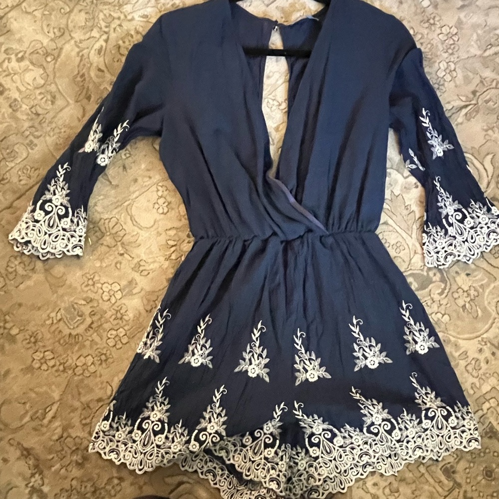 Never worn blue and white romper v-necked one button in the back